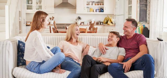 Family Sitting on a Couch at Home