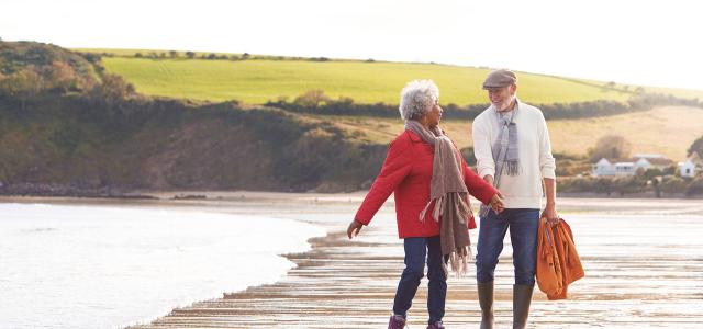 Retired Couple Walking by the Beach